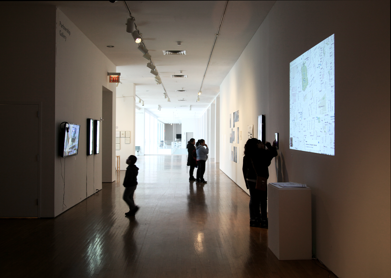  Exhibition view, with Anushya Badrinath's video  Kuwait, Egypt, India  (2013-16) to the left alongside Chitra Ganesh and Mariam Ghani's lightboxes  The Index of Democracy Is The Interval Between Inquiry and Info  (2013) and  Reasonable Articulable S