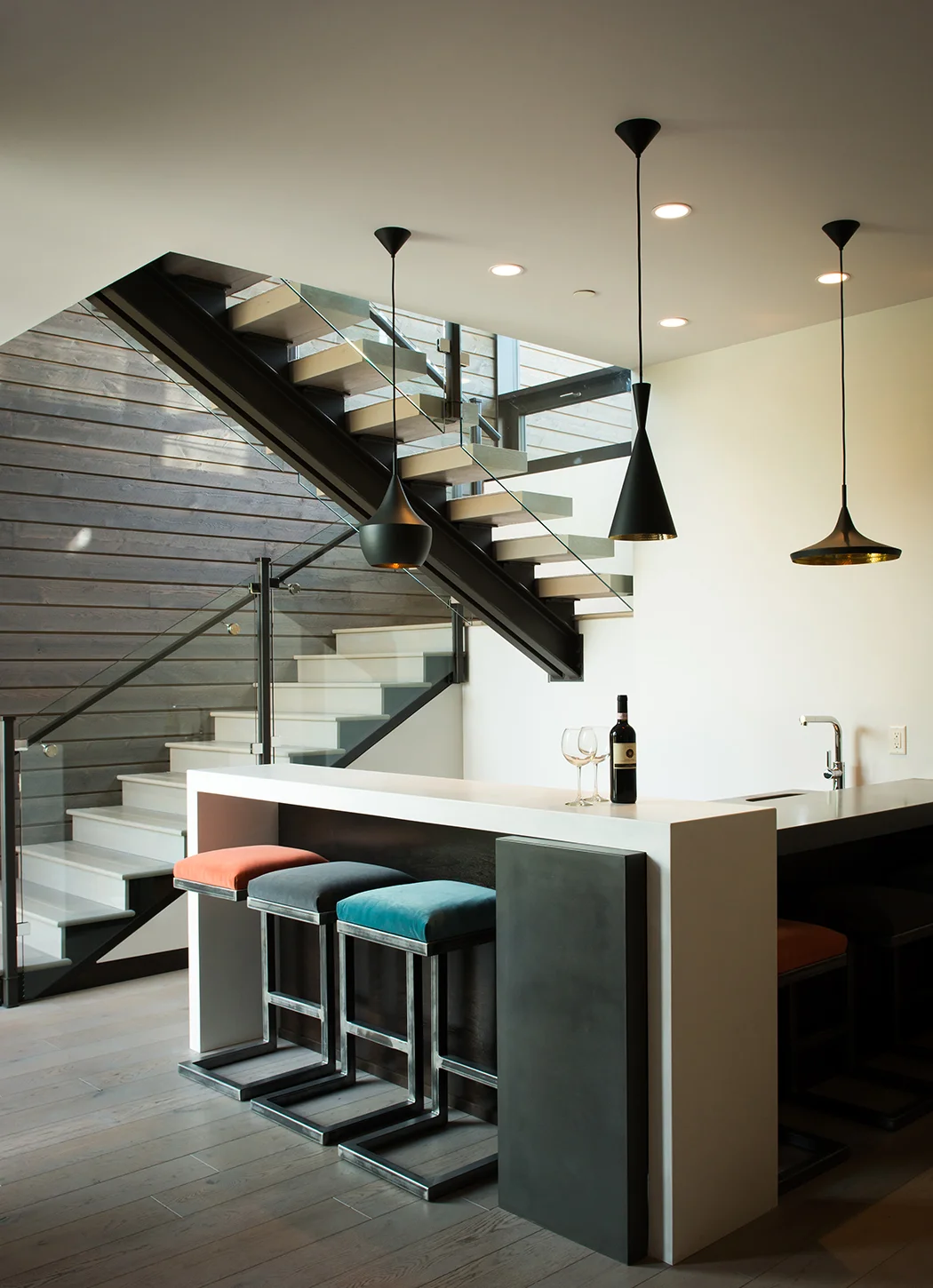 I love the natural lighting in this bar. The stairway and the pendants frame the bar perfectly & I little pops of color from the bar stools just adds to the composition.