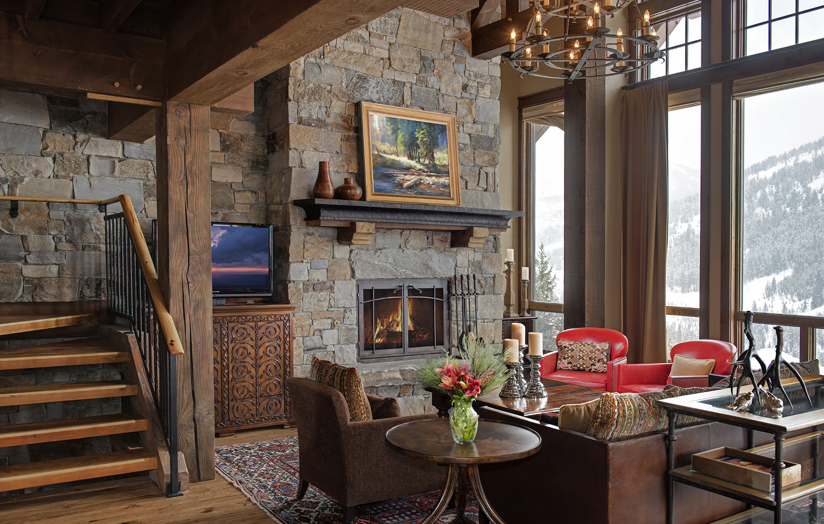 This Locati Architects designed home with the custom rock and wood timbers creates the coziest environment! This great room with its large fireplace is very welcoming after a day out on the Yellowstone Club ski slopes.
