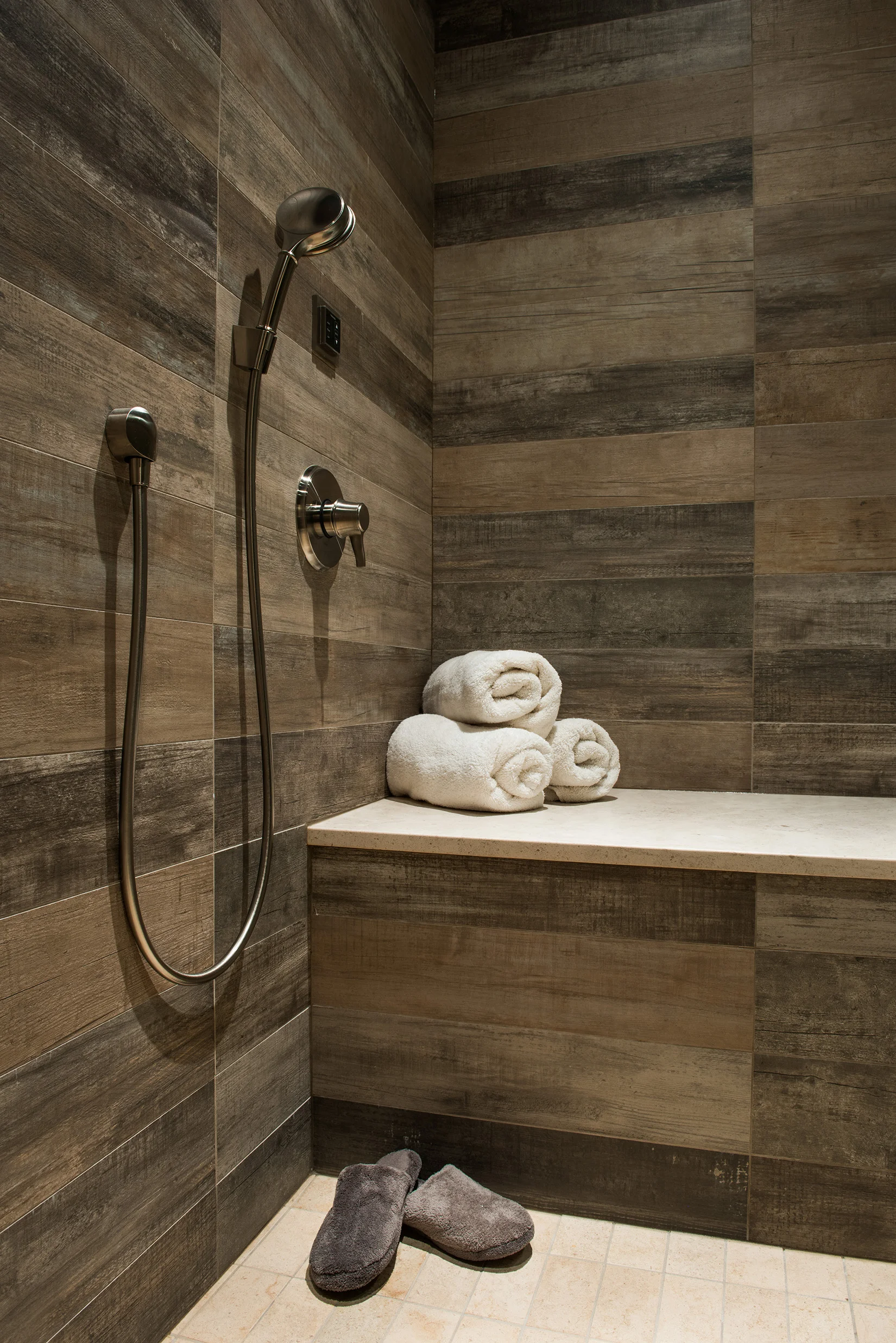 I could easily relax in this steam room with wrap around, barn wood style tile. 