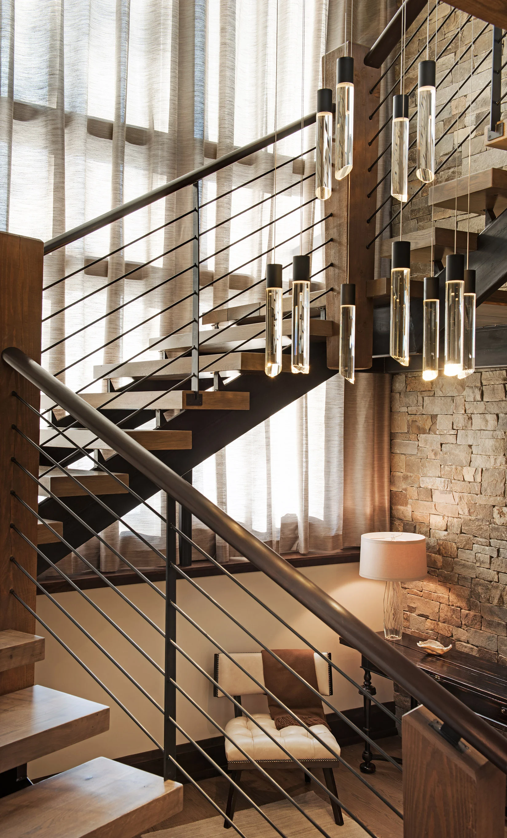 I love the modern staircase topped off with the gorgeous chandelier.