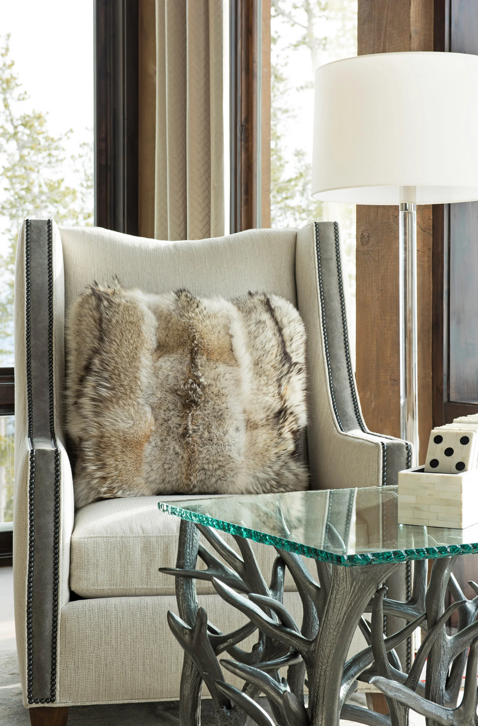 This cozy corner looks out at the ski hill at Yellowstone Club . I love the pillow and the gorgeous table!! Interior Design - Varda Interiors