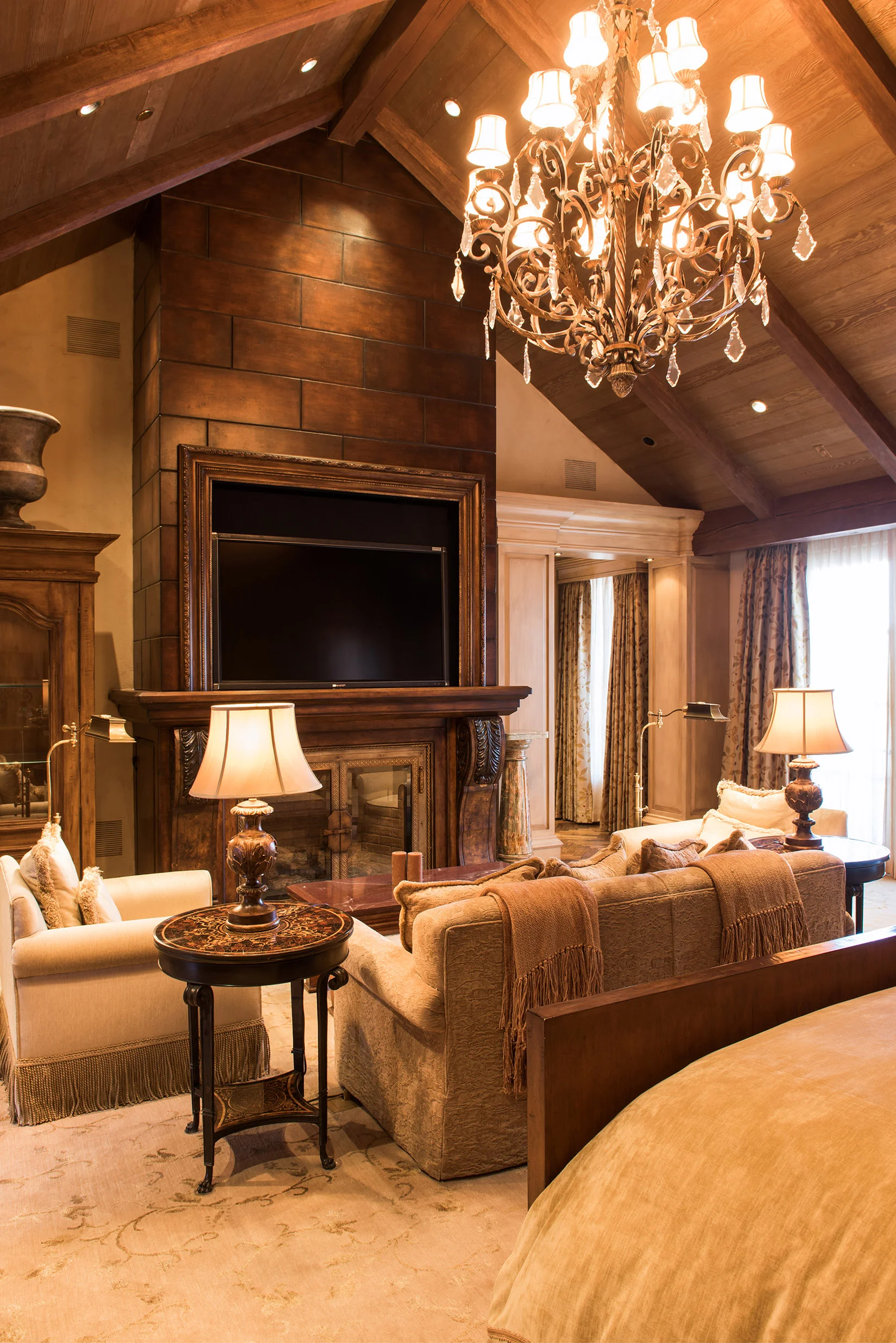 The master bedroom is a great place to relax with the tall, vaulted ceilings and grand fireplace.