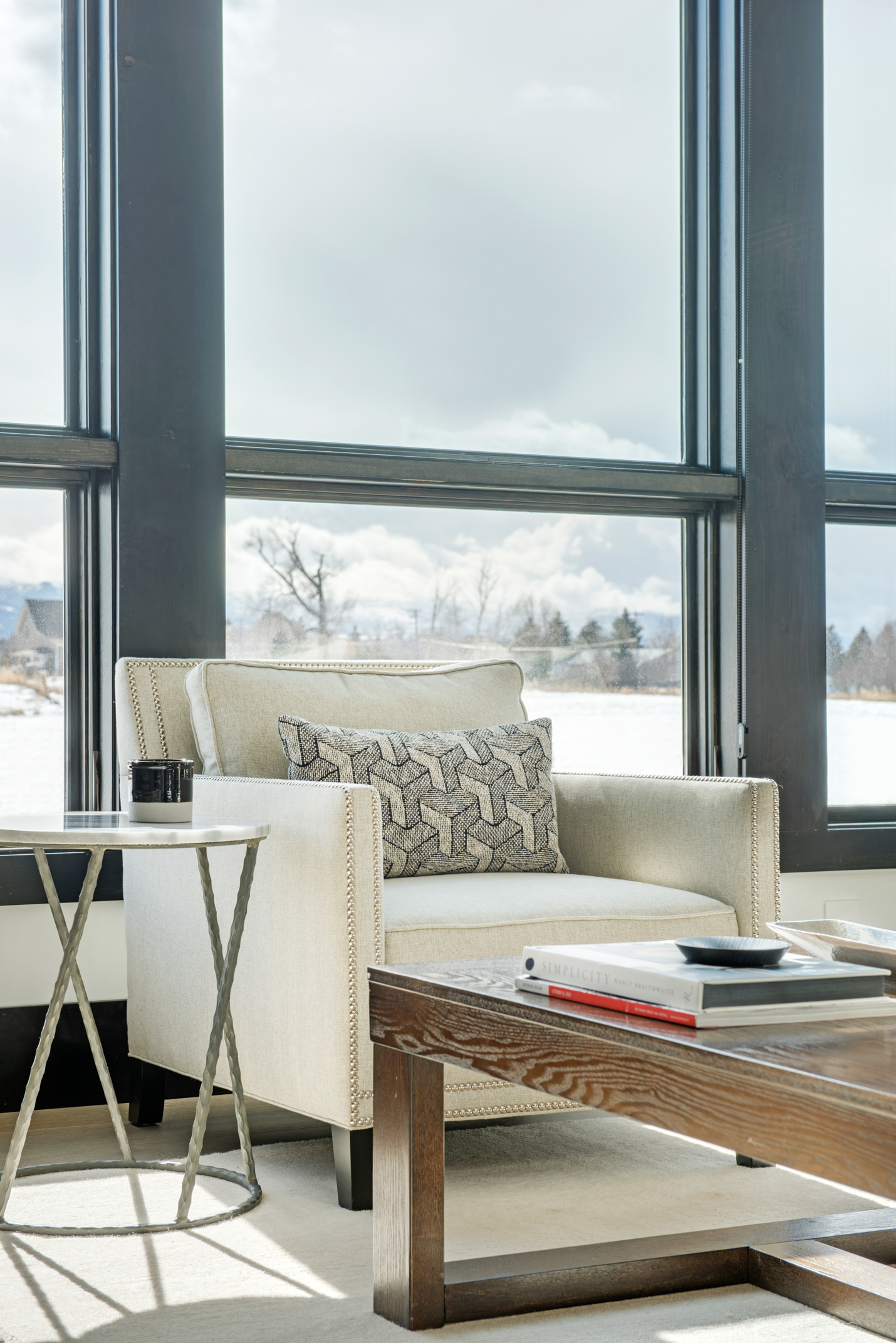The great room has amazing views and the contemporary look of the windows is complimented with the stylish furnishings. I love the geometric patten on the pillow!