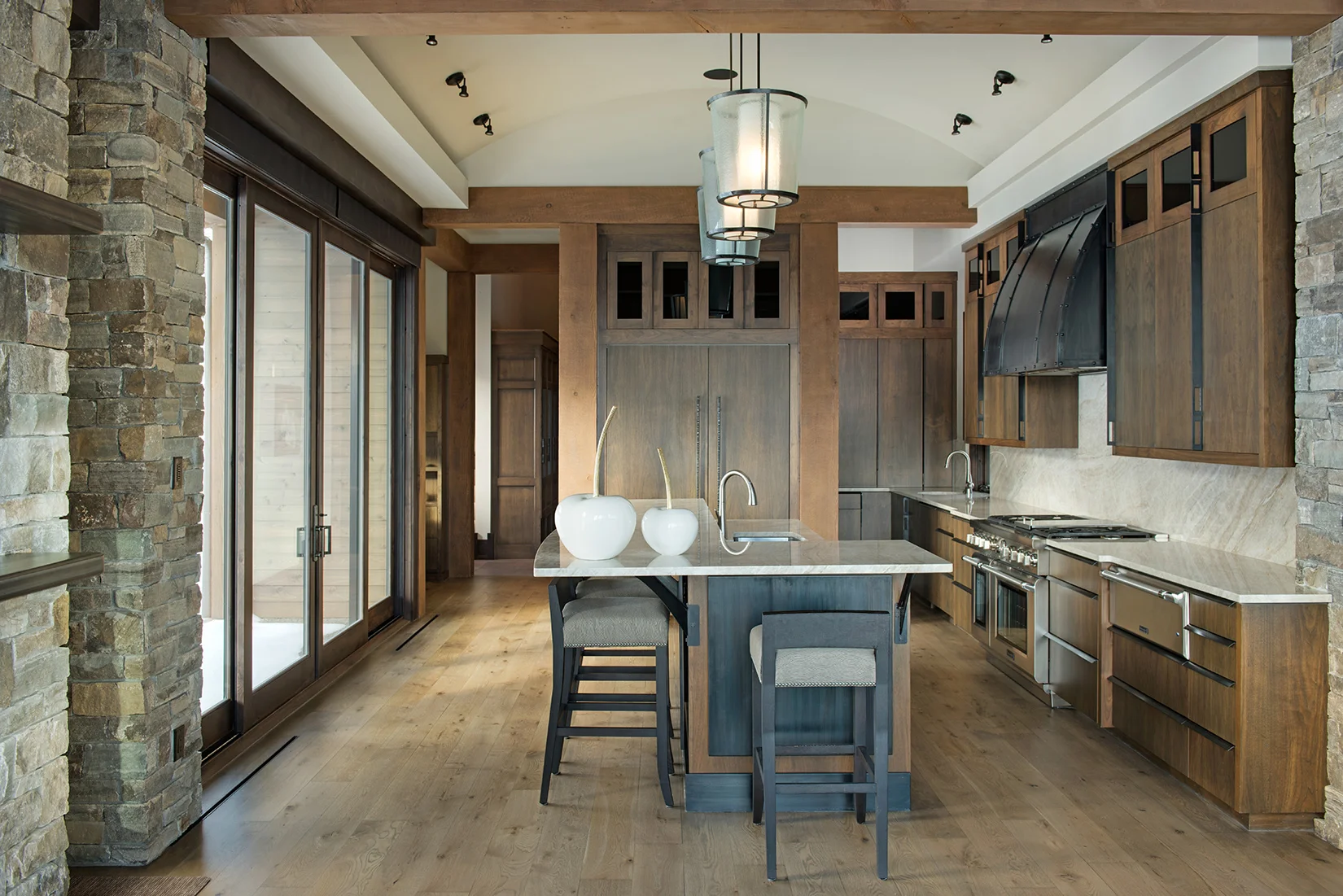 This kitchen blends the rustic tones with a contemporary look. Design by Varda Interiors