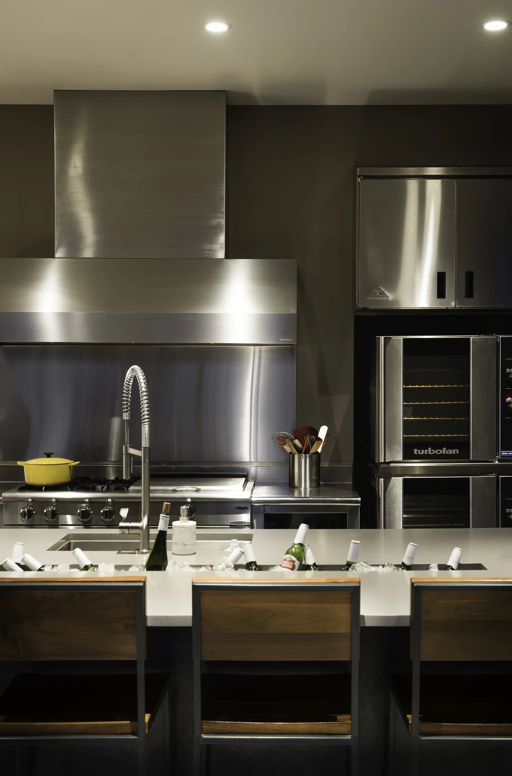 The custom sunken cooler on this counter is amazing in this commercial style kitchen. Architecture Design by Reid Smith Architects
