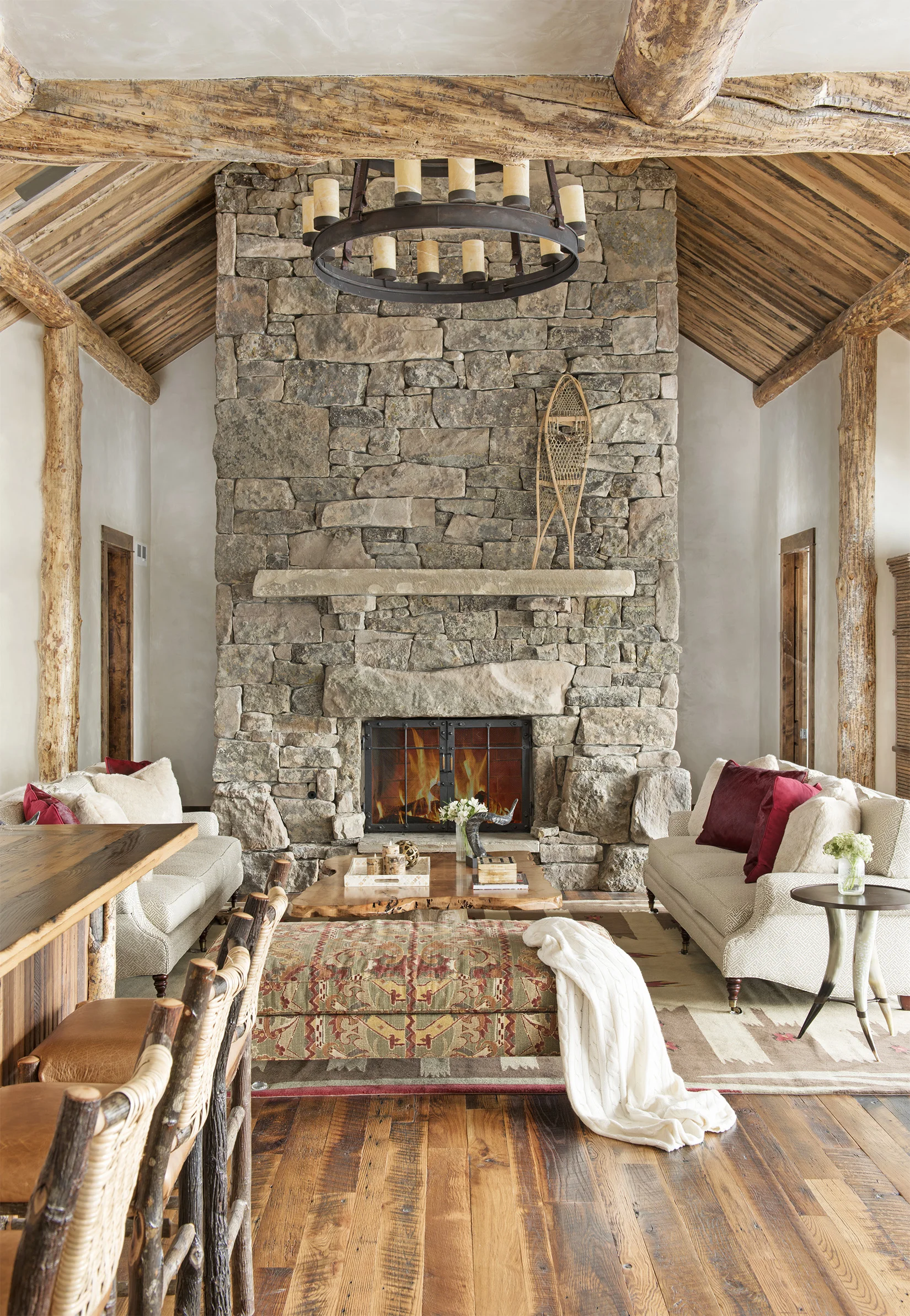 The textures are so impressive in this room - from the custom stone fireplace to the wood floor and wood beams throughout. Very impressive. Located in Yellowstone Club.