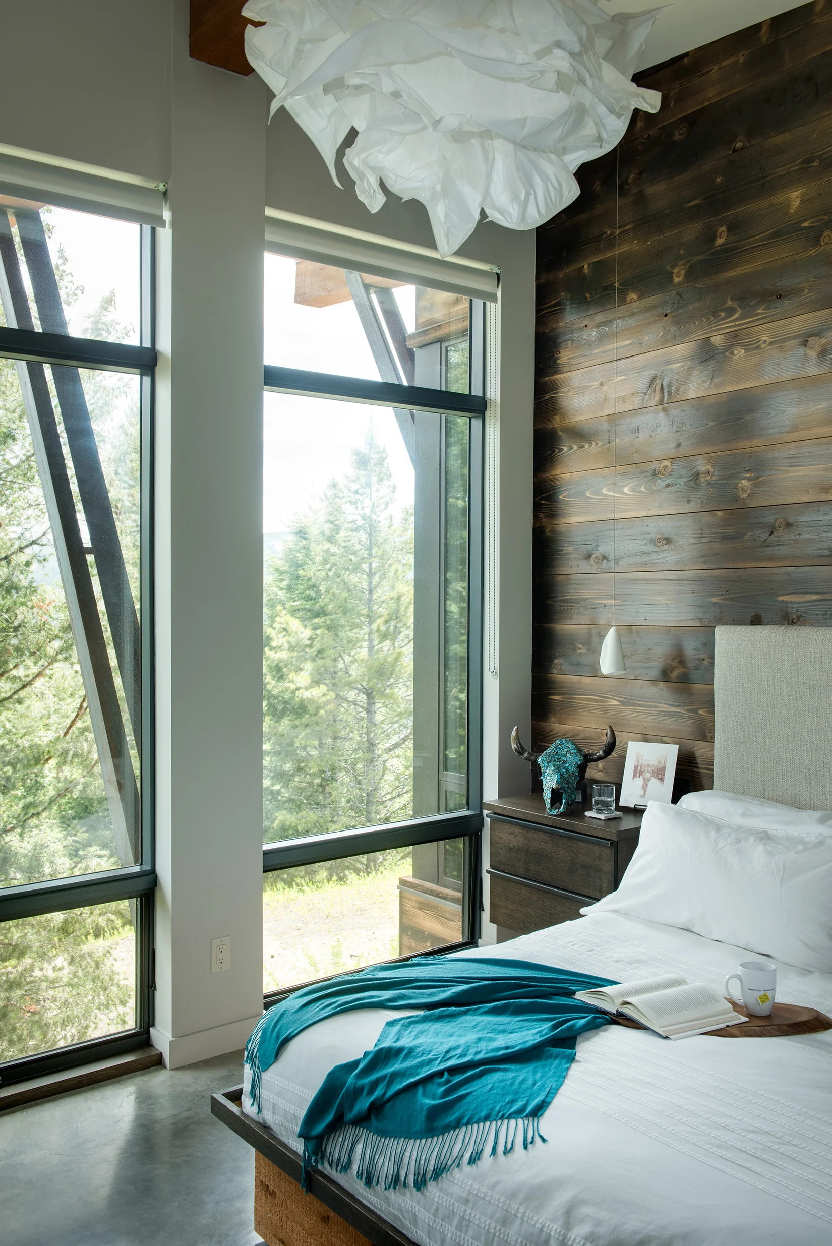 This is a perfect example of contemporary rustic. The exposed wood on the wall is stunning and is a great use of raw, natural elements. The burnt style is known as Shou Sugi Ban and is just stunning. Architect - Reid Smith Architects , Builder - Big Sky Home Builders