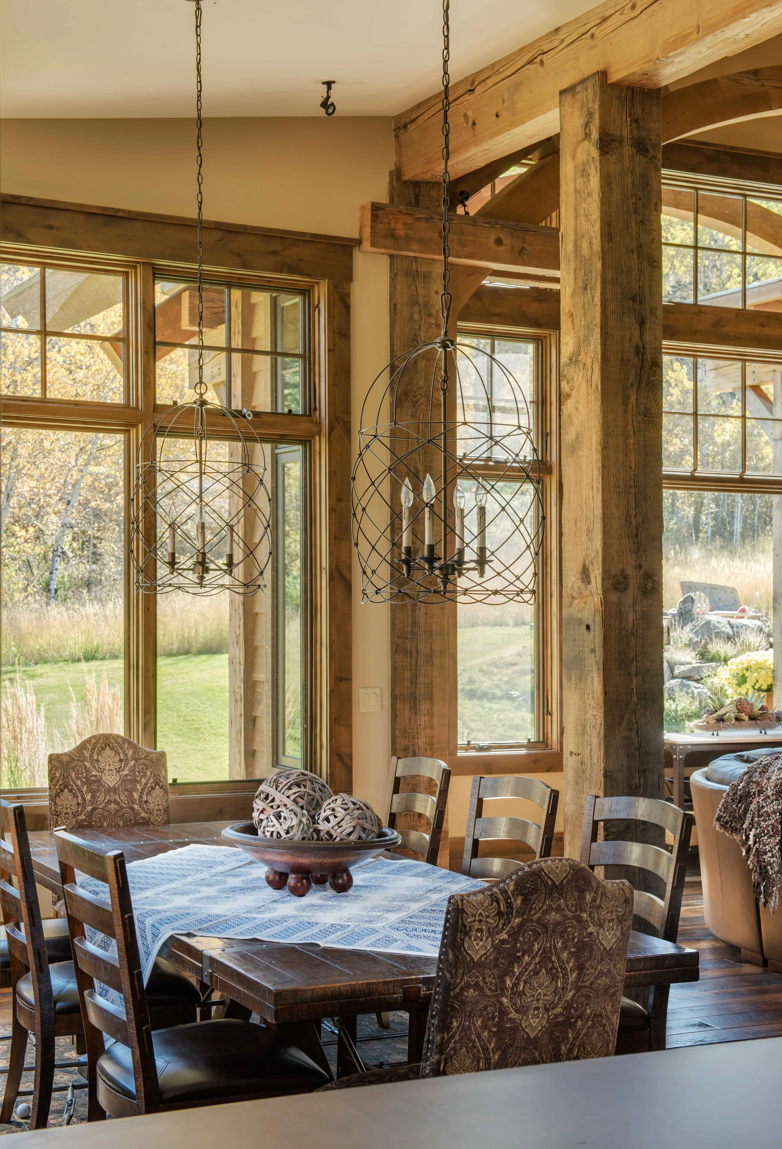 The combination of the strong wood beams and the distressed iron hanging lights are gorgeous in this rustic dining room. Architect - Reid Smith Architects Builder - Schlauch Bottcher Construction