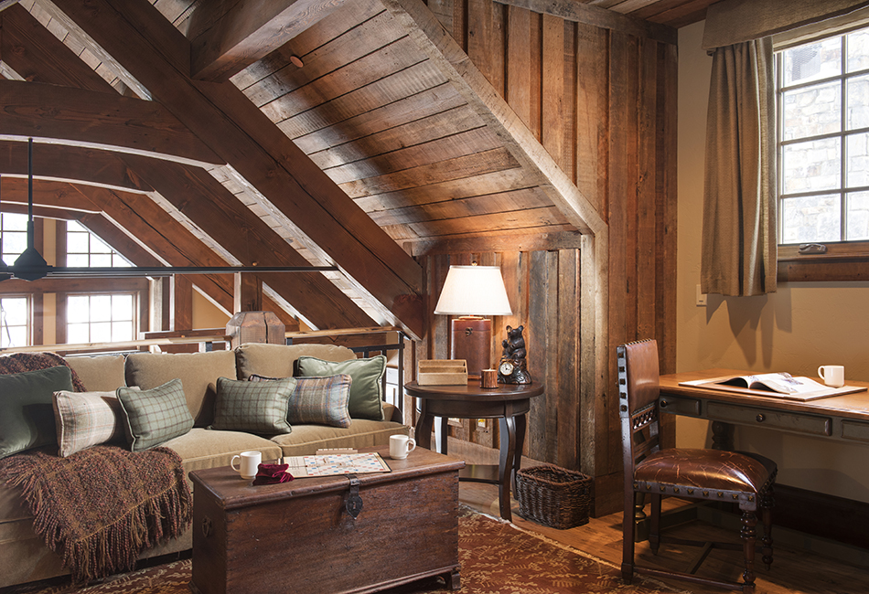 This cozy nook has all the rustic elements with the wood paneling and exposed beams. Architect - Locati Architects 