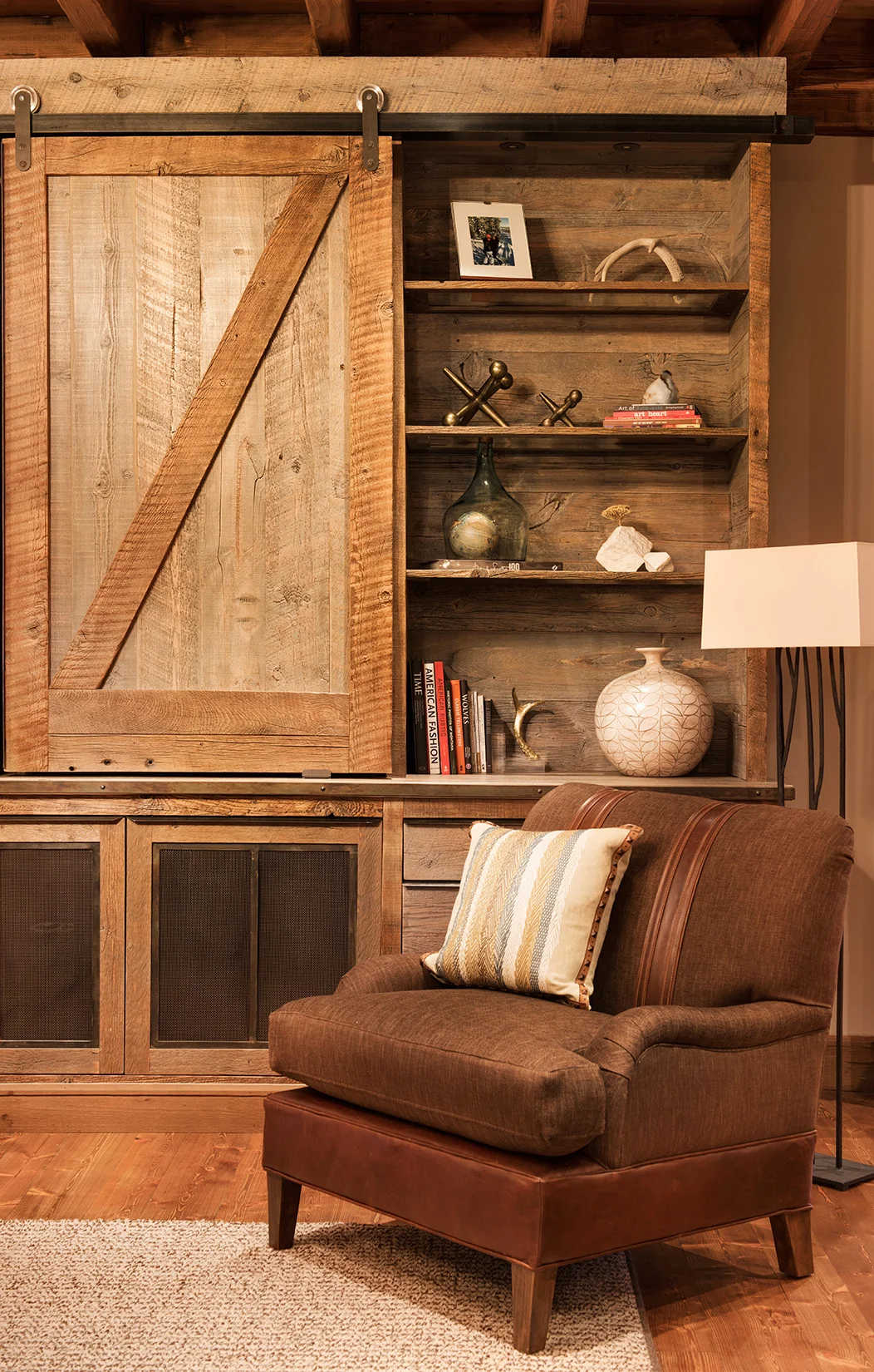 The sliding barn door and reclaimed wood shelves are fantastic! Interior Design - Varda Interiors