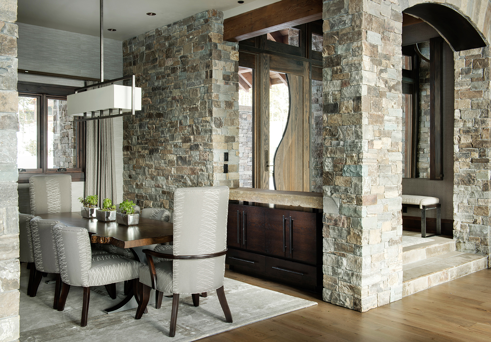 This custom stone work is what draws me to this amazing dining room. So wonderful! Varda Interiors , Yellowstone Club