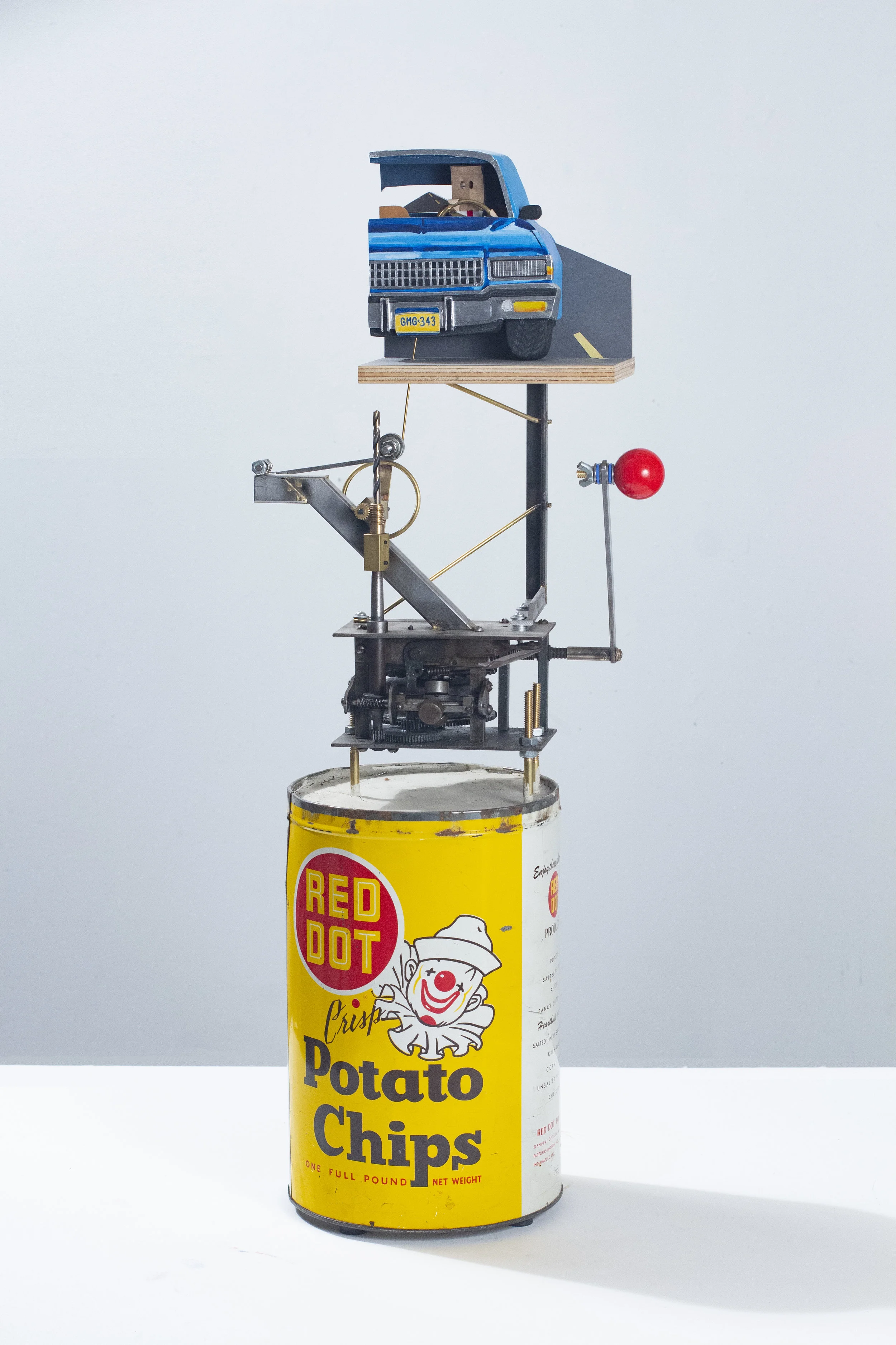 “Executive Toy: the lonely road” 11.5x28.5x7 inches Concrete, vintage tin, steel, brass, arcade game joystick, plywood, hardware, sandpaper, flashe, silica bronze, paper bag, skateboard bearing, denim, paper, cotton and phonograph motor