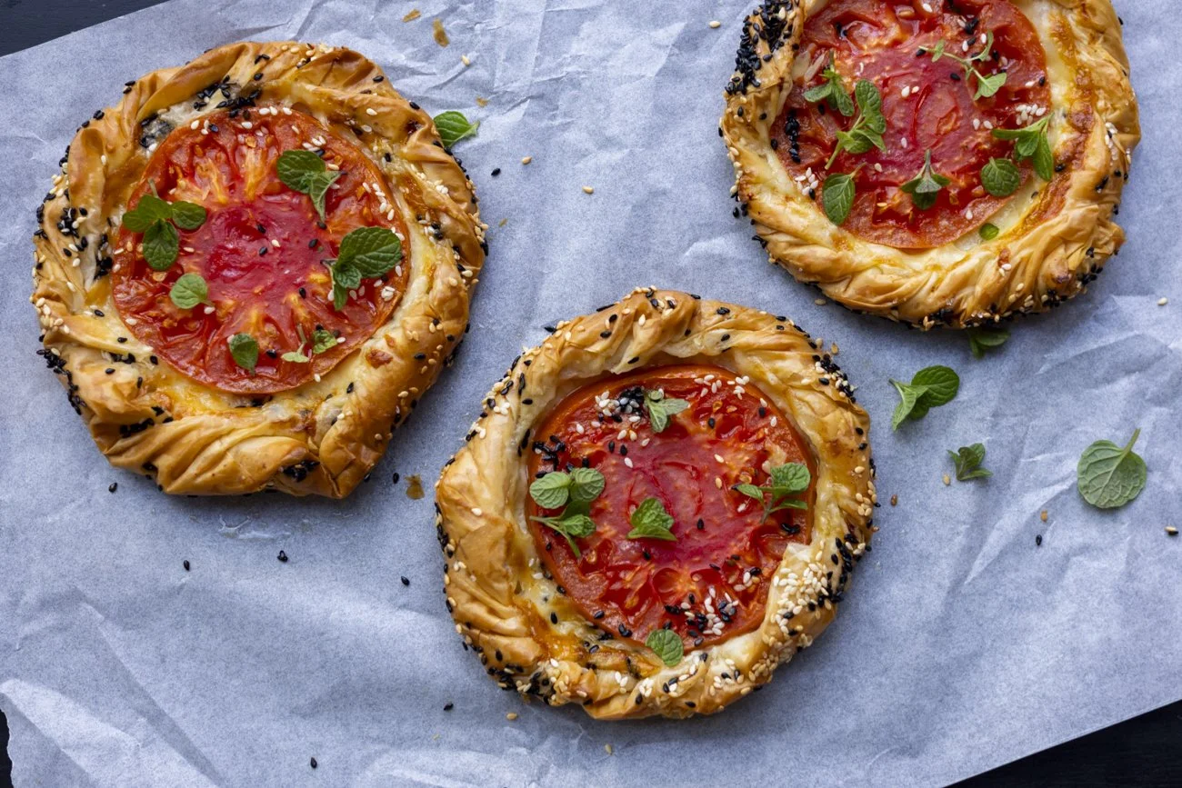 golden crispy fillo pastry tart base with melted cheese and sweet red tomatoes