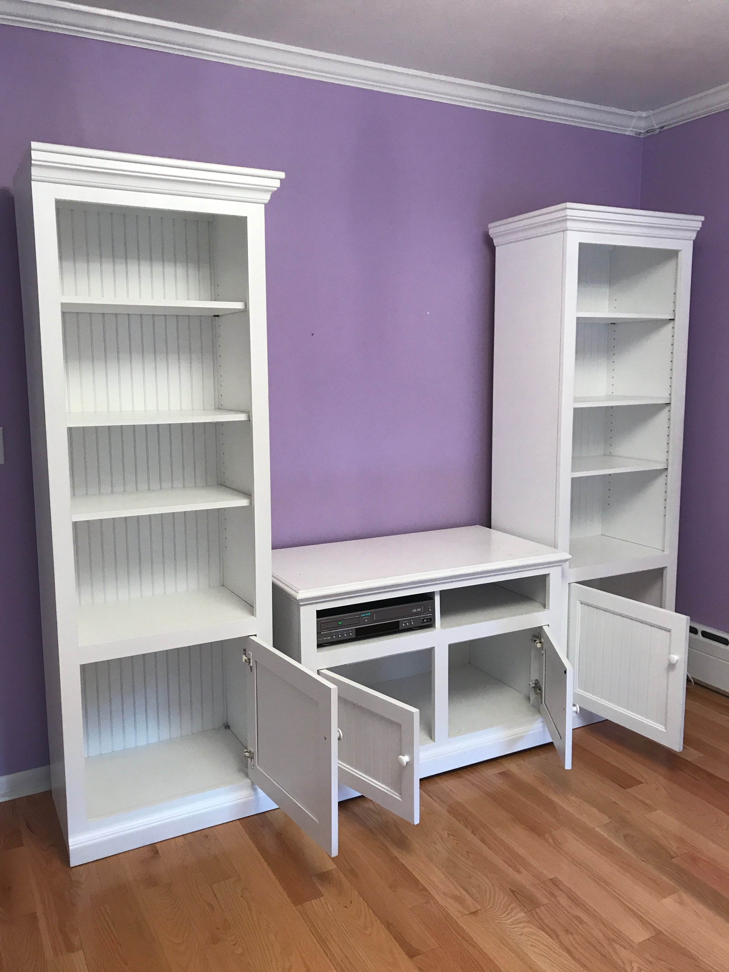 pair white bookshelves and entertainment cabinet