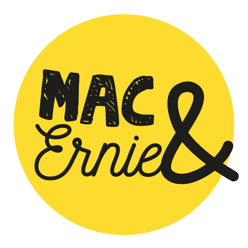 Yellow circular sign with black text reading "MAC & Ernie" in a casual handwritten style.