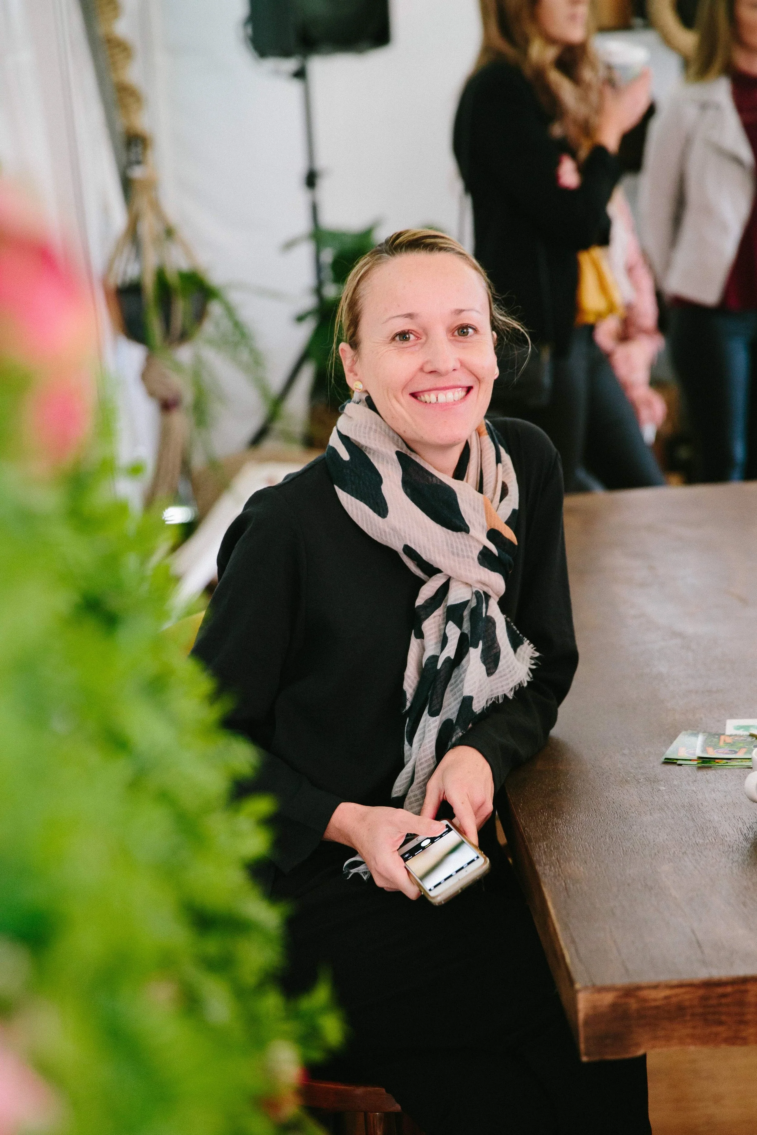 Erika McInerney smiling at a table during a business networking event in Gippsland.