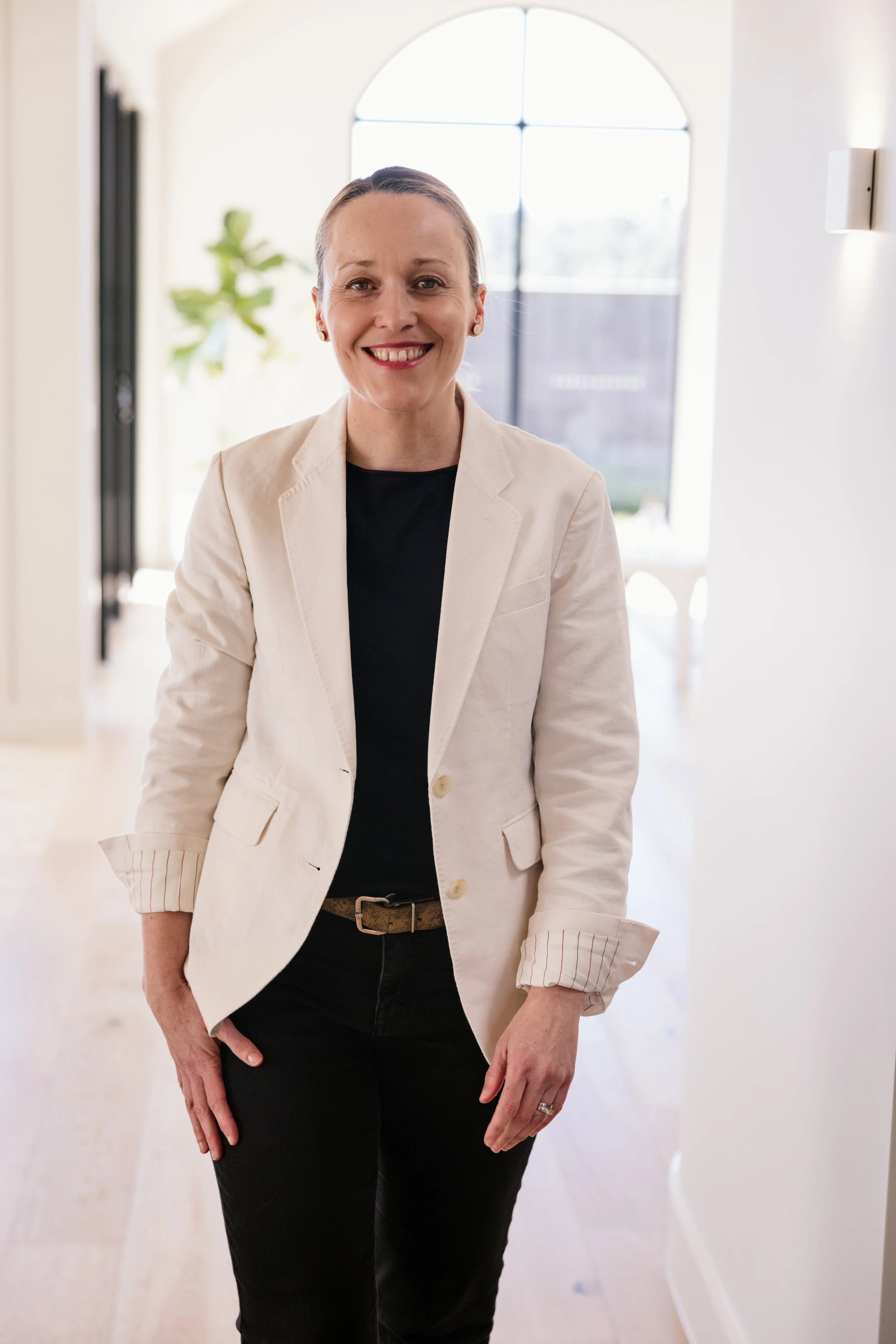 Erika McInerney, founder of Mac&Ernie, standing in a light-filled interior space