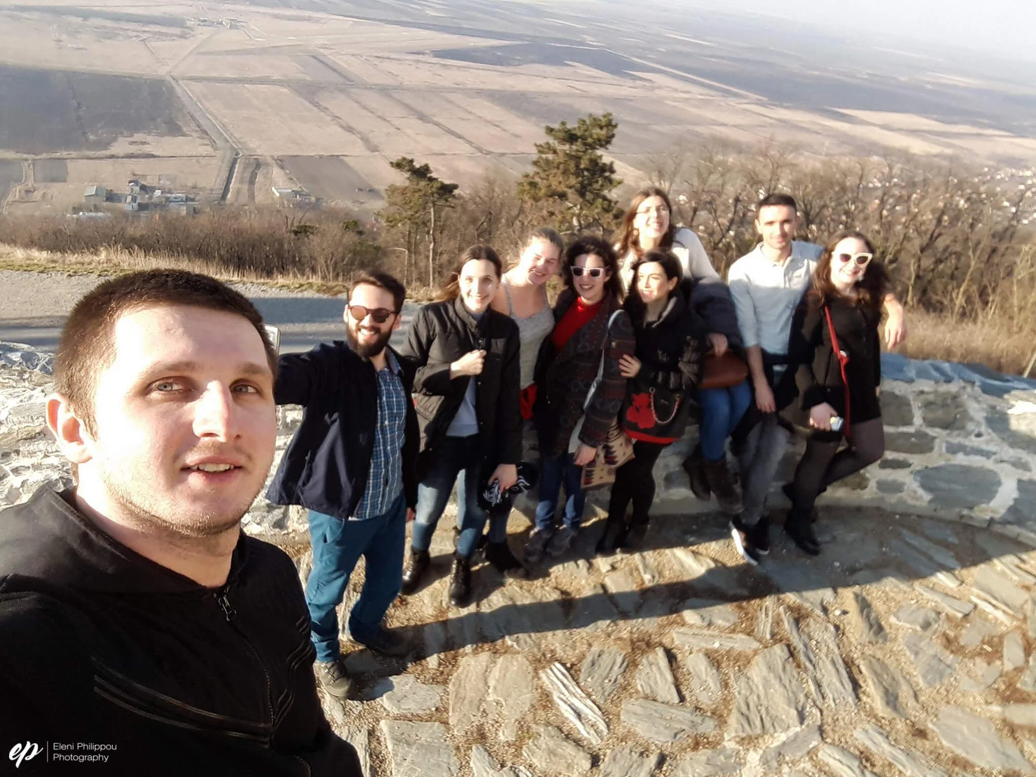 Happy faces trying to catch their breath upon reaching the top of the hill at the tower, overlooking the whole city. The fields behind border Romania.