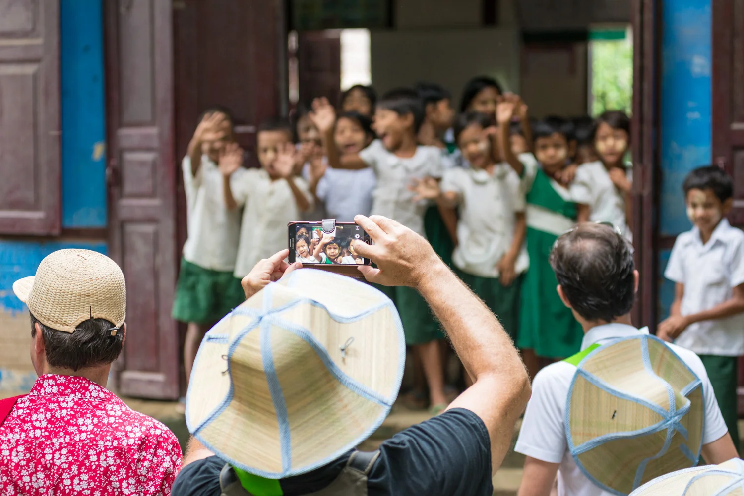 Schoolchildren greeting Bellini Club members