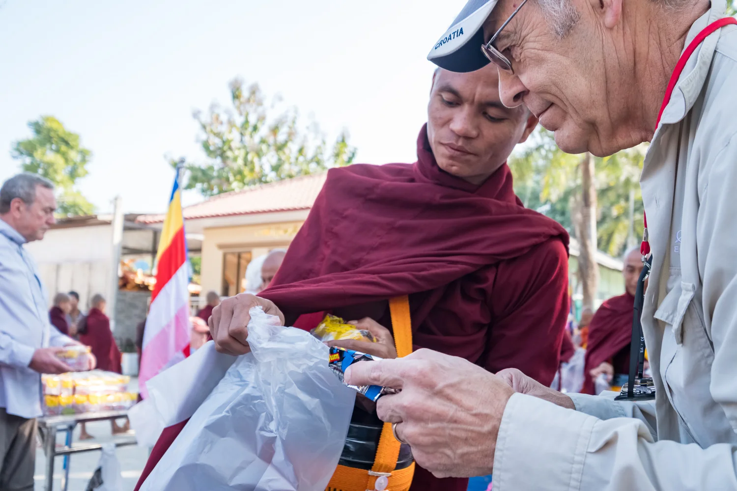CEO member giving alms
