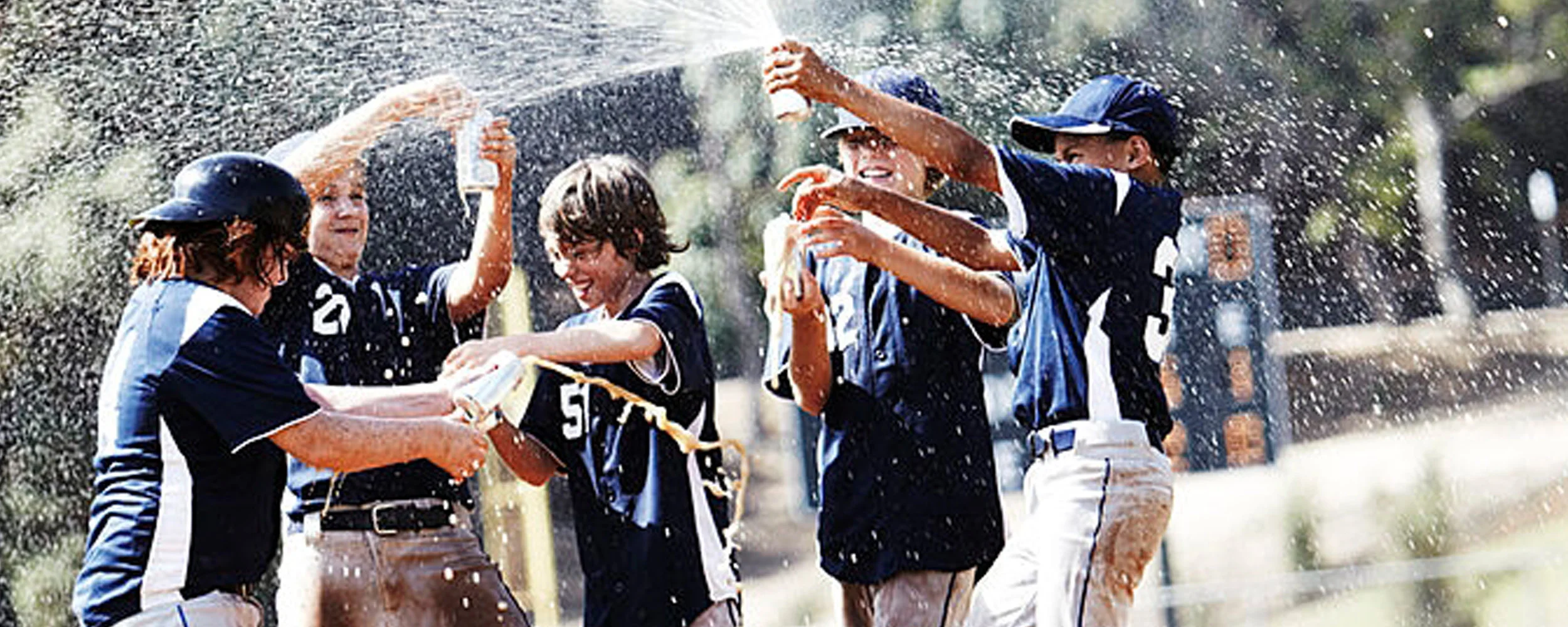 Scene 2: I want to create visuals that look good in slow motion. Adding a flying particulate such as liquid , dust or dirt will add visual interest to these shots. Here is an example of the boys spraying a beverage. Dumping the Gatorade cooler on the coach is always a classic.