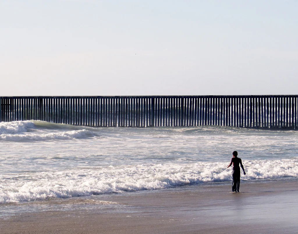 A boy near the border fence at Playas de Tijuana.