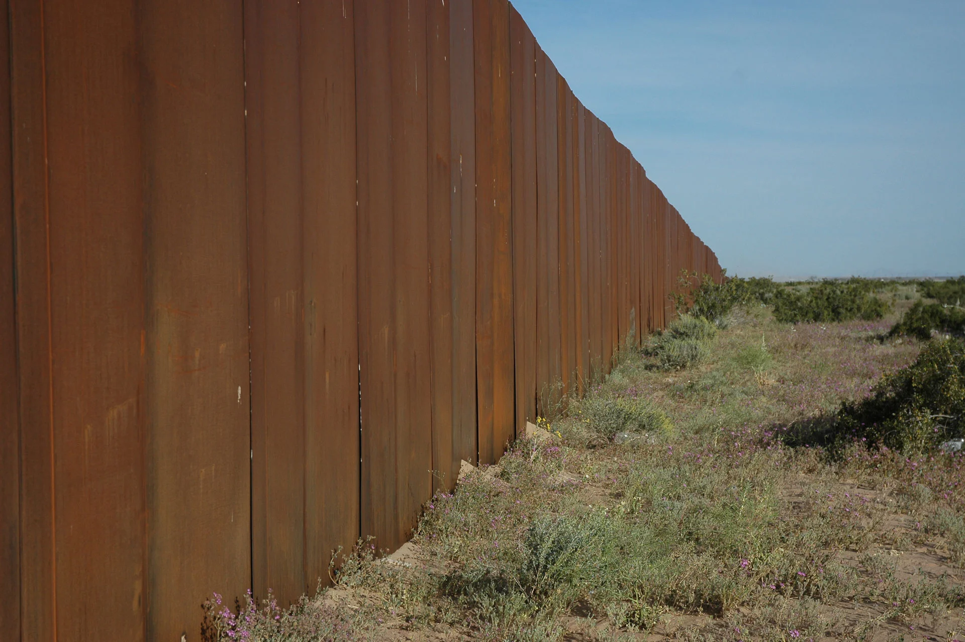 The Wall, US border, separating Mexico from the US, looking east, along Highway 2, Sonora Desert, Mexican side
