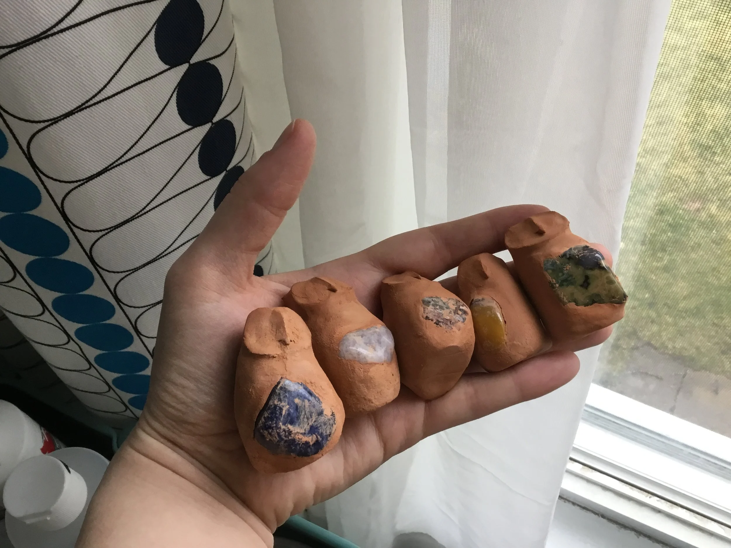 More sculpted owls. These guys are made with natural red clay. L--R: sodalite, amethyst, leopard jasper, mookaite jasper, and rainforest jasper (Jasper is my favorite, can't you tell?) 