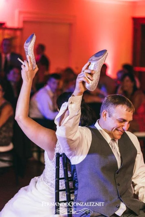 Laughter fills the room during the "Shoe Game." Our Wedding DJs are expert MCs who know how to engage your guests and keep the celebration moving with fun, personalized moments.