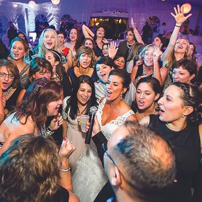 Energetic wedding reception with guests on the dance floor at a Rochester NY venue served by Sound Express Entertainment DJ