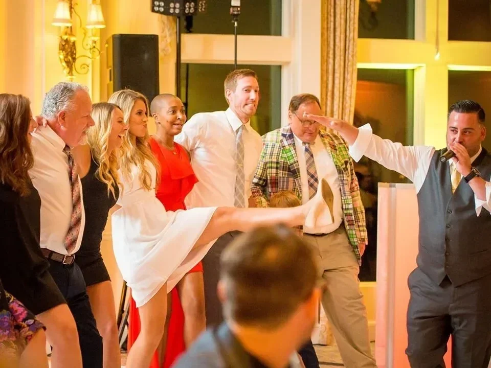 Wedding guests celebrating and dancing together at a reception by Sound Express Entertainment in Rochester, NY.