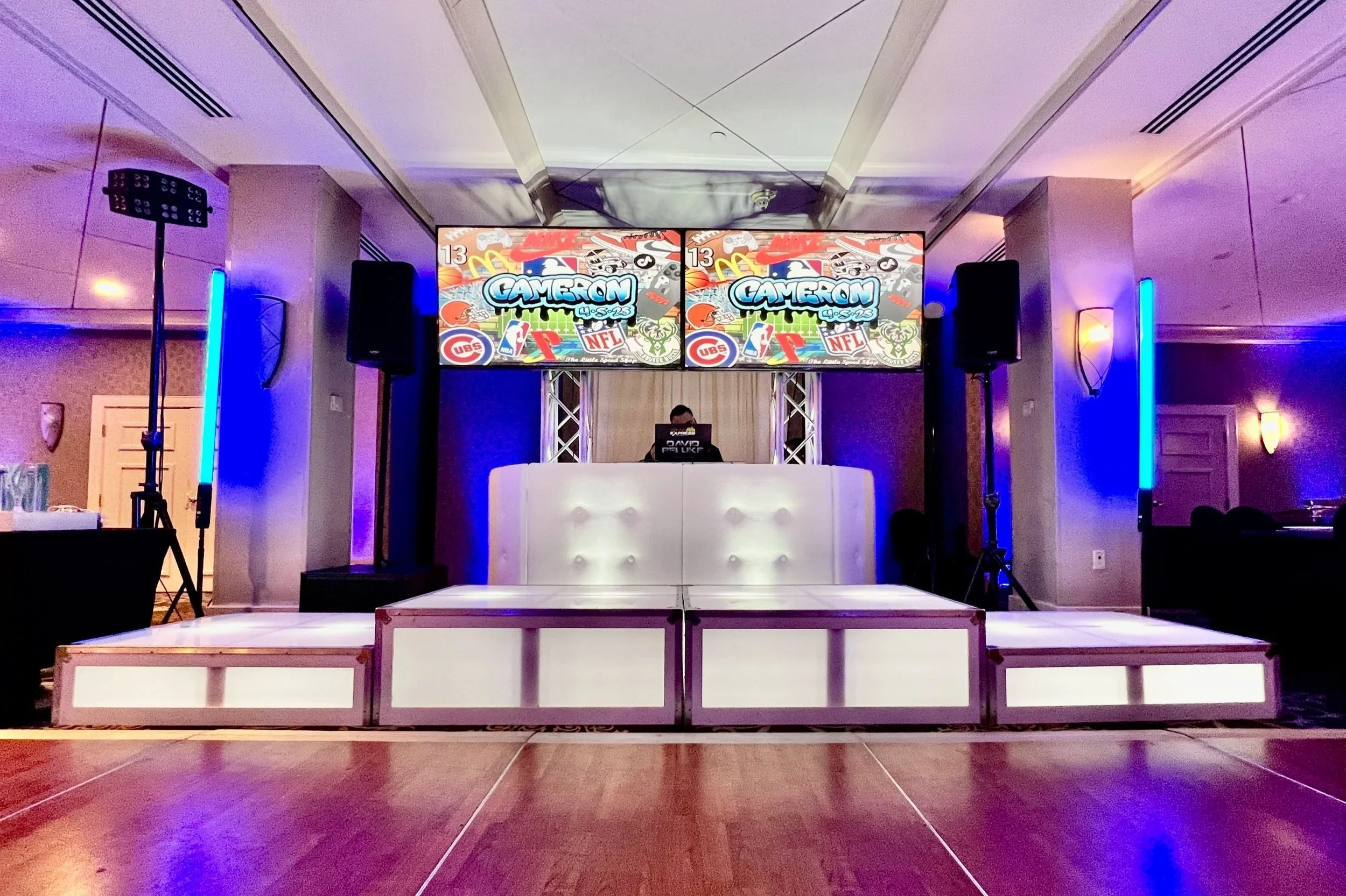 Elevated glowing acrylic dance stage providing a VIP lounge vibe for a wedding reception.