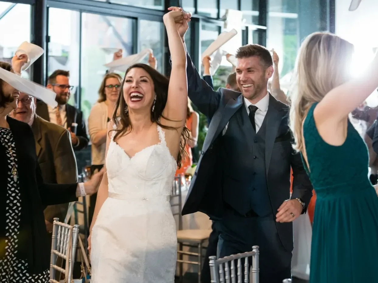 Bride celebrating joyfully on a packed dance floor during a wedding reception by Sound Express Entertainment in Rochester, NY.