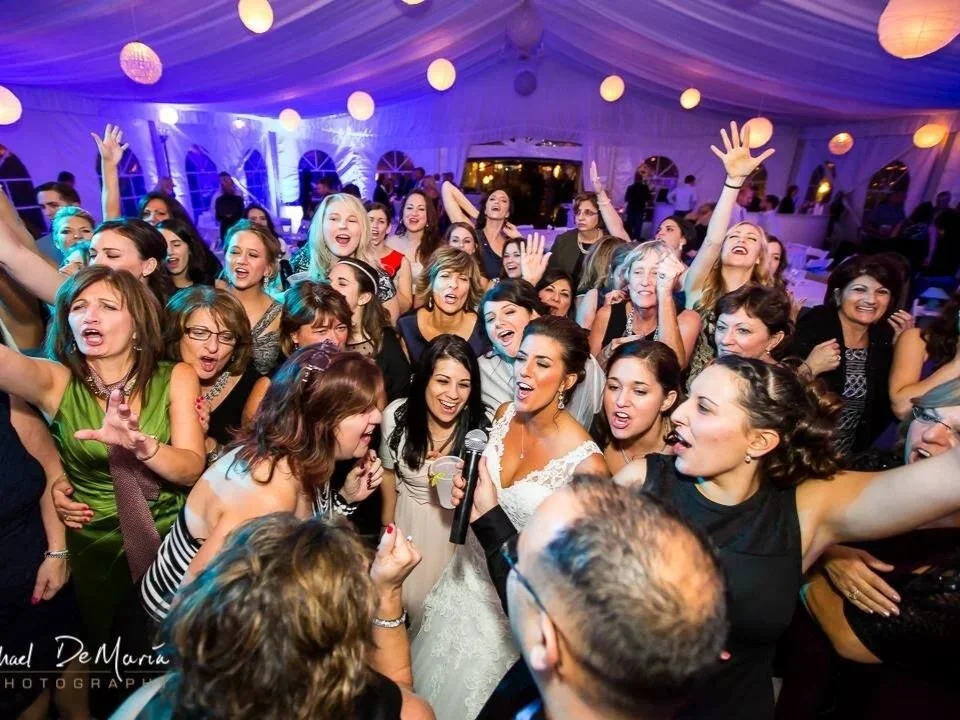 Packed wedding dance floor with energetic guests celebrating at a reception by Sound Express Entertainment in Rochester, NY.