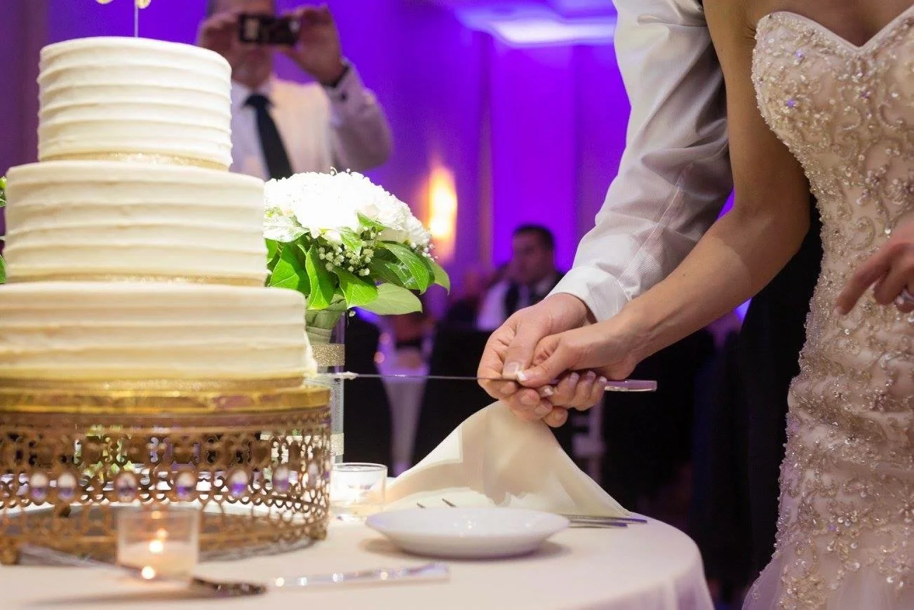 Bride and Groom cutting cake at a Rochester NY wedding reception featuring Sound Express Entertainment DJ services.