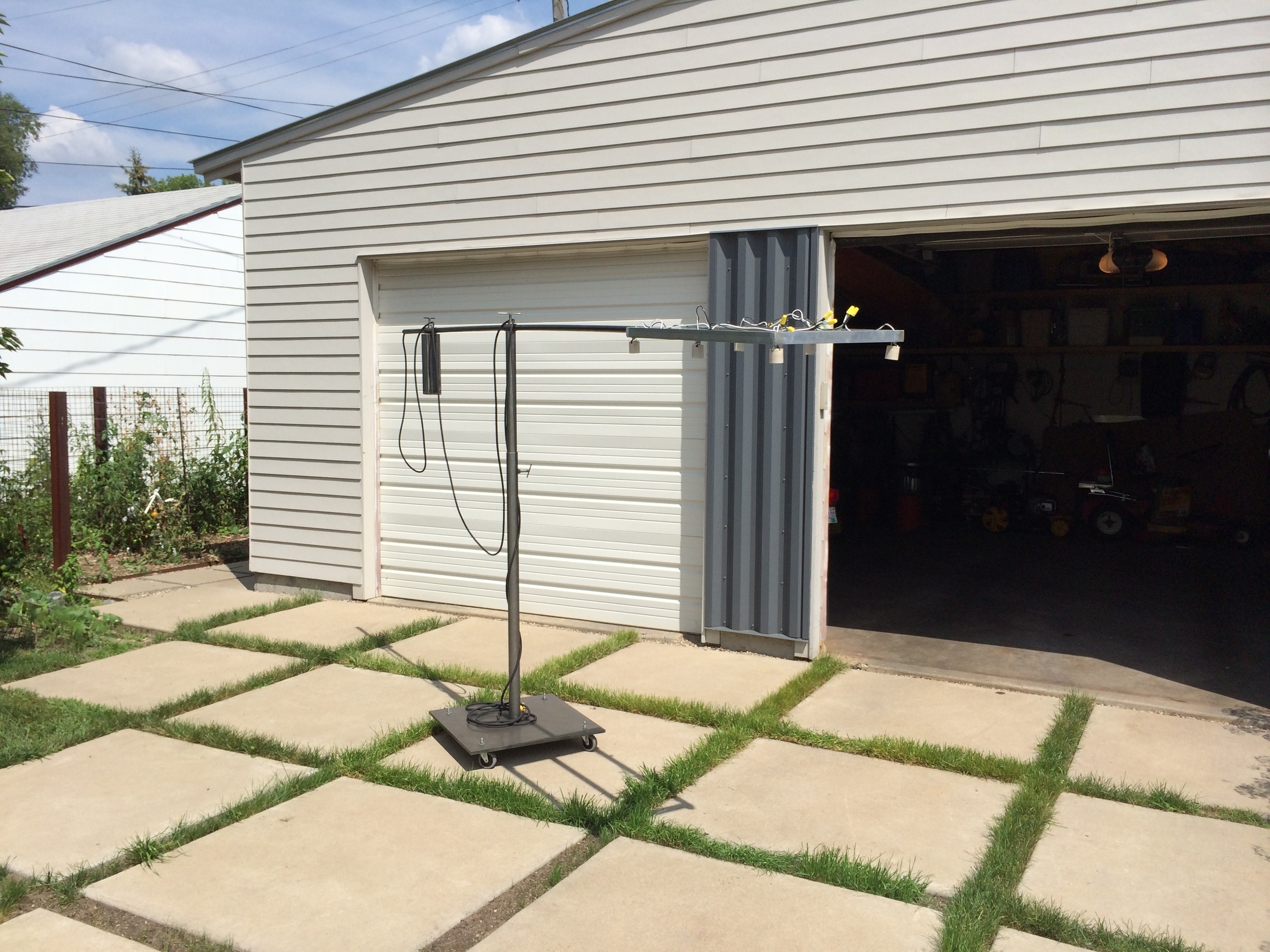  Collaborative work with  rolu . &nbsp;Inspired by a light in a gallery. &nbsp;Aluminum light frame with steel telescoping arm, counter weight and telescoping base on a rolling 1/2" steel plate base. 