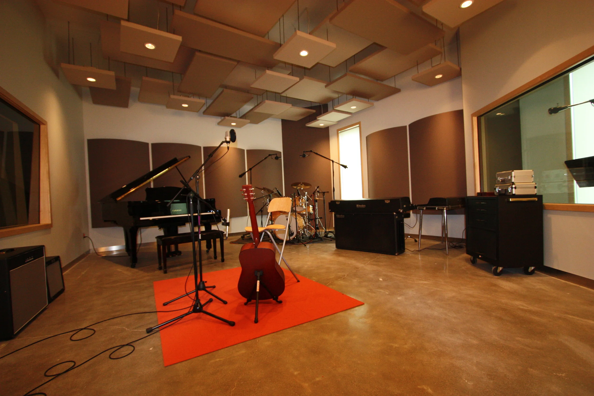  Live room with isolation booth for vocals. &nbsp;This room is built completely isolated from the rest of the structure. &nbsp;This creates an acoustically sealed space. &nbsp;Fabric covered panels line the walls and ceilings to assist with sound con