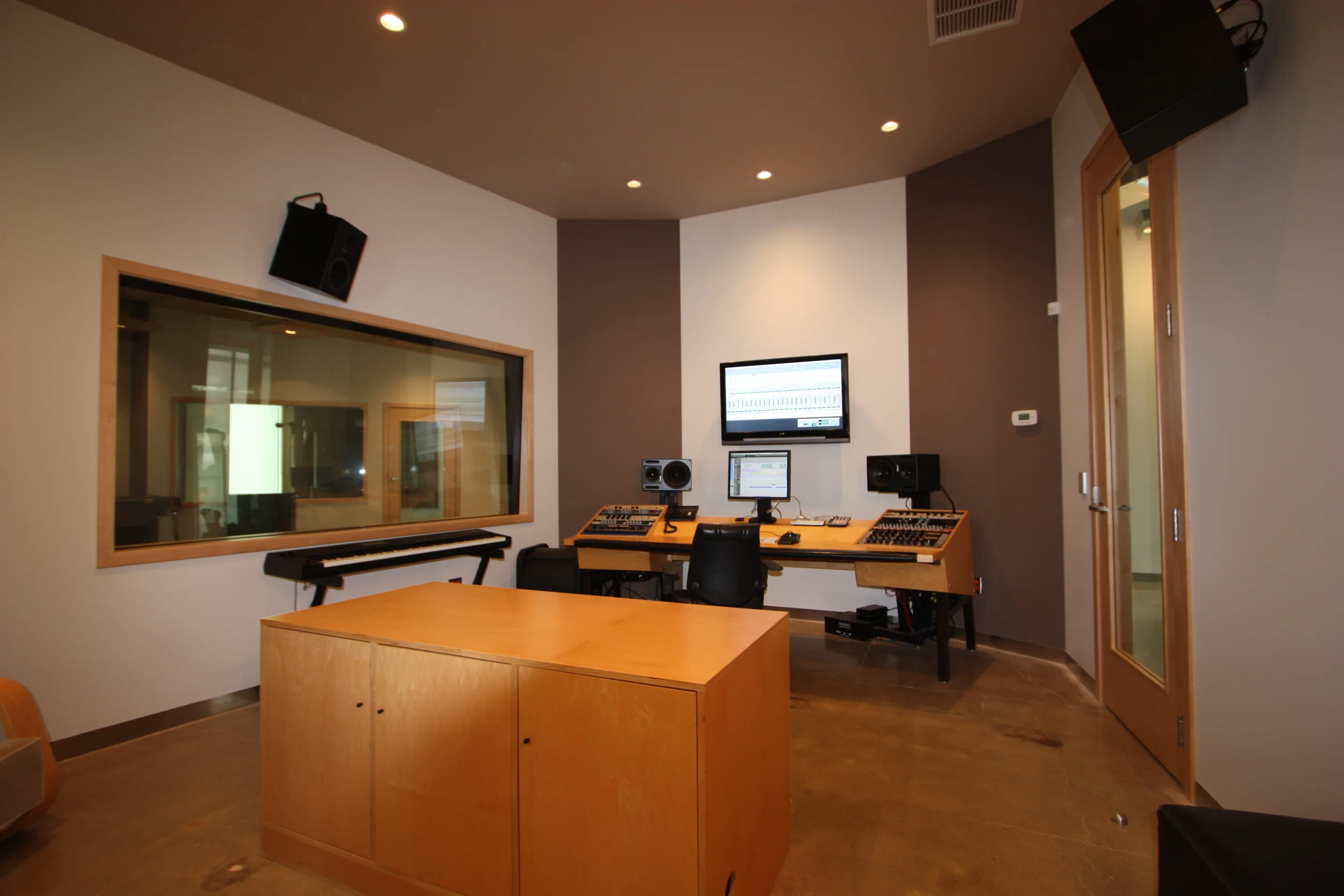  Control adjacent to the live room. &nbsp;The ceiling is a continuous fabric covered panel with acoustic treatment behind to control sound. &nbsp;Corners have a similar fabric covered acoustic treatment as the live room. &nbsp;The glass separating th