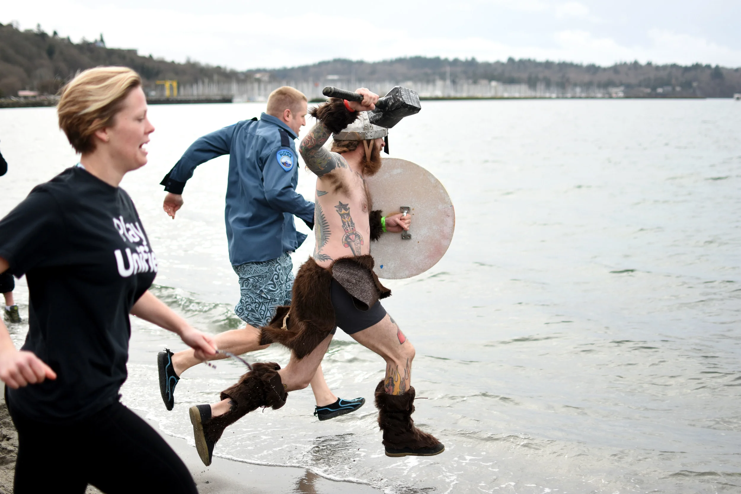  A member of the Nearly Nekkid Norwegians leads the charge among a group of "super" plungers who charger into the Puget Sound multiple times on Feb. 6, 2016 for the Special Olympics fundraiser.&nbsp; 