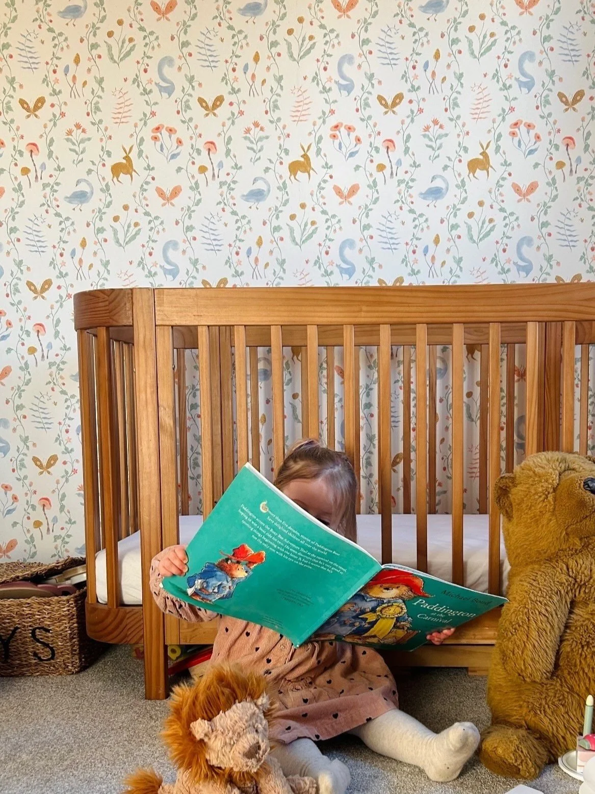 Nursery with wallpaper featuring colorful animals and plants, whimsical nursery design, kids bedroom design, interior design, kids bedroom ideas