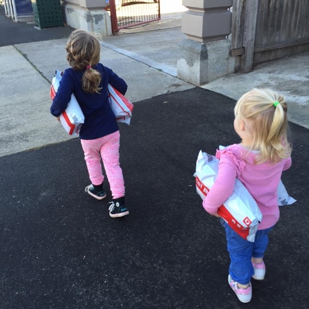 Two little girls delighted to be helping their self employed mother deliver parcels from Fair Dinkum Dog Coats to the post office.