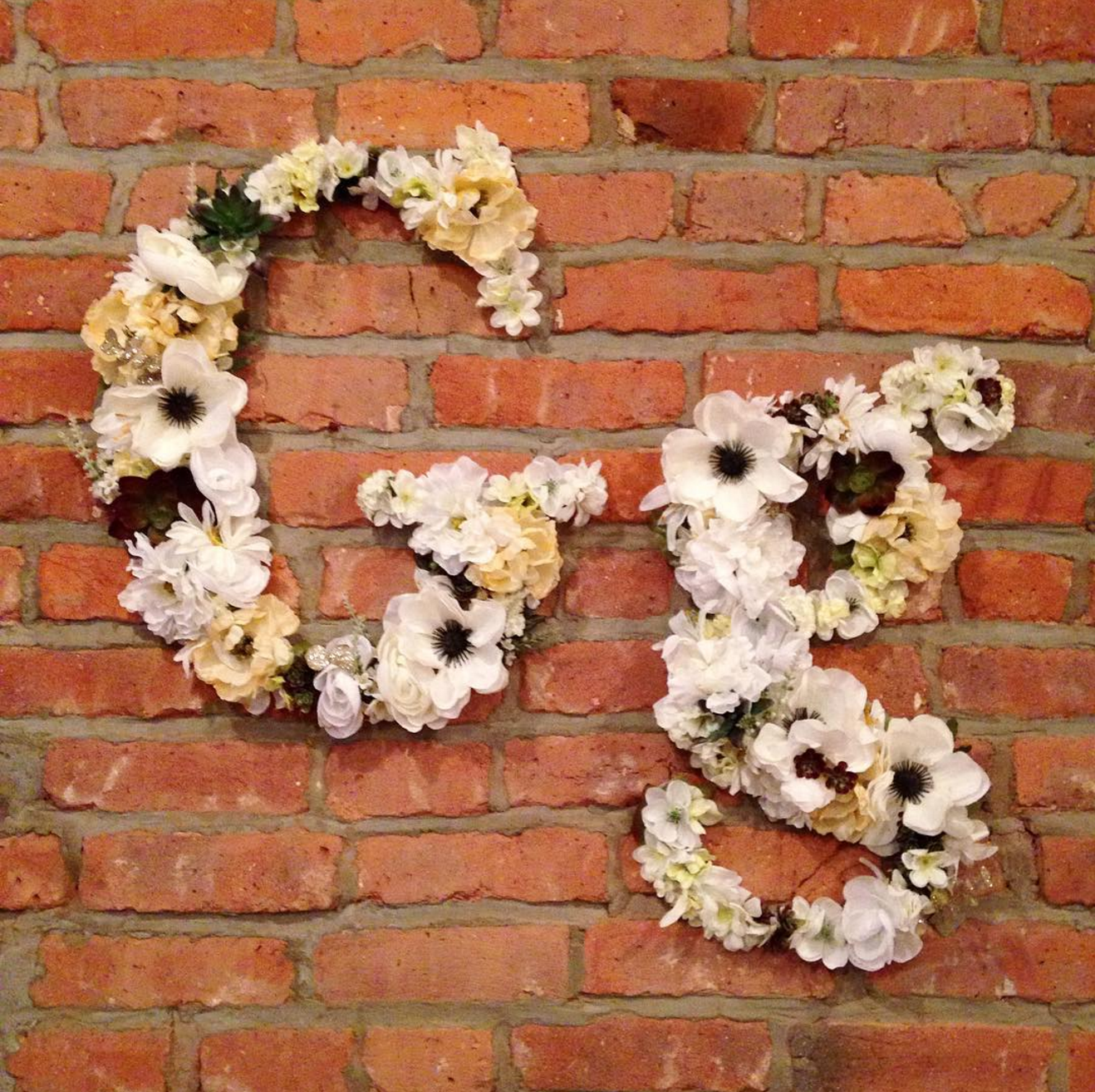 Faux flower typography wall hangings.