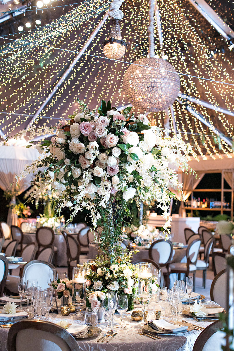 Hotel Bel-Air wedding reception with chandeliers and string lights, florals designed by Eddie Zaratsian, Photo by Jessica Claire Photography