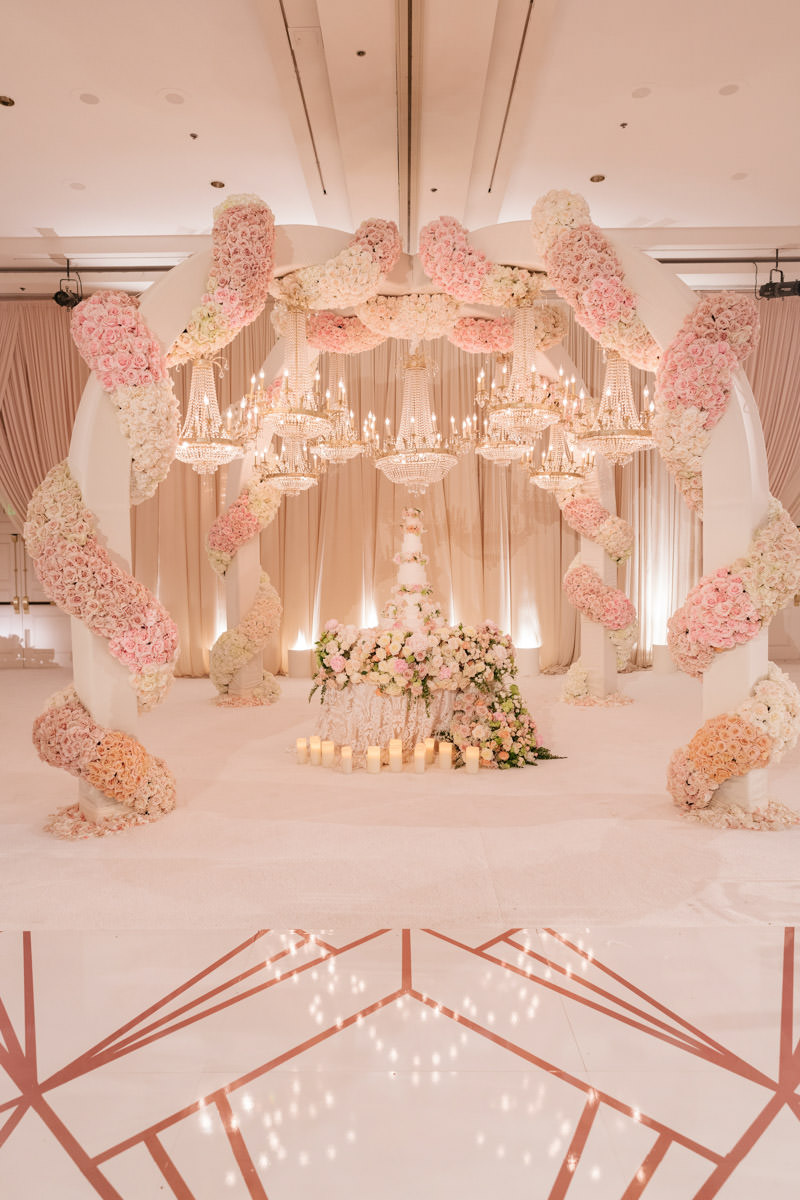 Spectacular pink, cream and copper wedding cake display and sweetheart table florals designed by Eddie Zaratsian, photo by Kris Kan