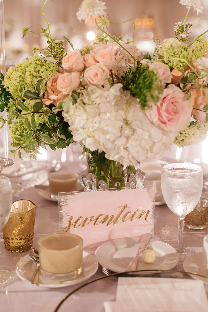 Pink, cream and copper wedding reception floral centerpiece and table number designed by Eddie Zaratsian, photo by Kris Kan
