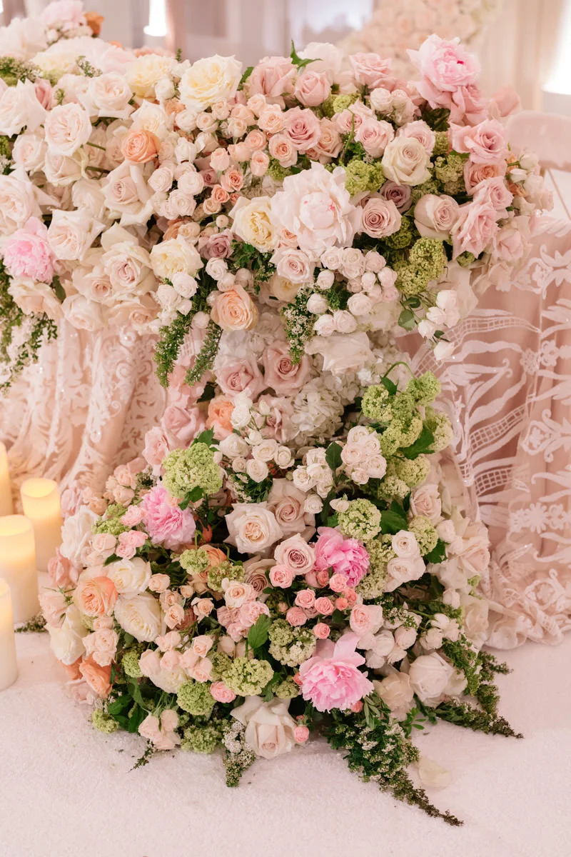 Wedding reception sweetheart table overflowing with pink and white roses - florals designed by Eddie Zaratsian, photo by Kris Kan