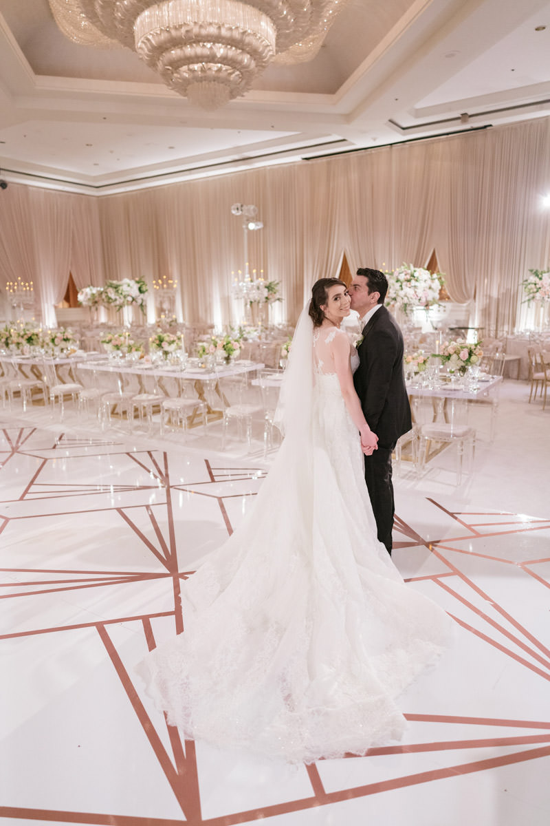 Bride and groom in their modern pink, cream and copper wedding reception - designed by Eddie Zaratsian, photo by Kris Kan