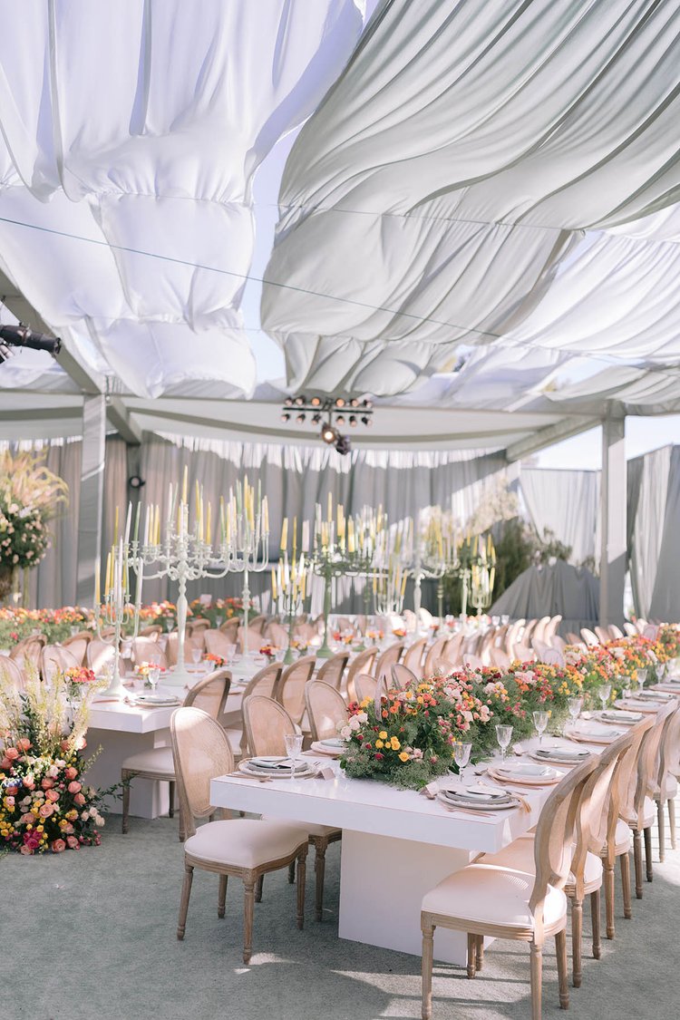 Colorful spring wedding florals on long dinner tables in a tent - LA reception designed by Eddie Zaratsian Lifestyle and Design