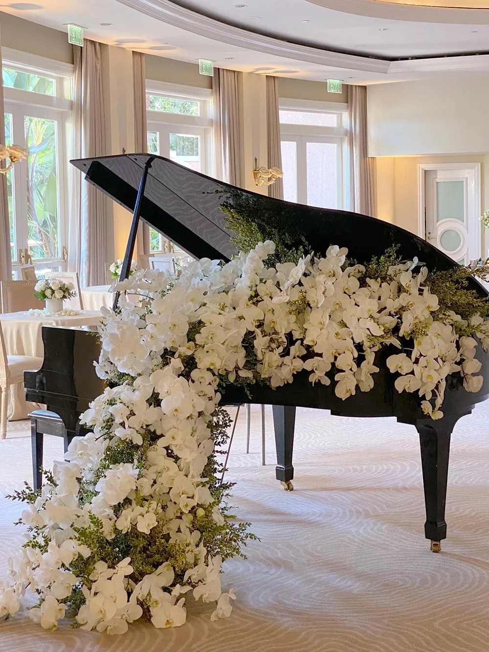 Grand piano filled with white orchids at The Beverly Hill Hotel, designed by Eddie Zaratsian Lifestyle and Design